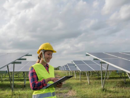 Engineer electric woman checking and maintenance of solar cells.
