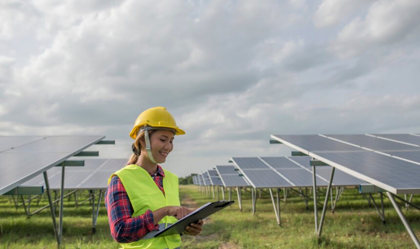 Engineer electric woman checking and maintenance of solar cells.