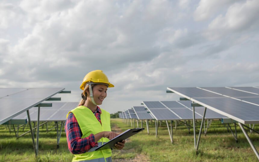 Engineer electric woman checking and maintenance of solar cells.